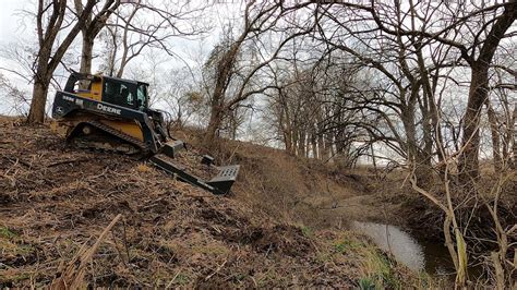 using a skid steer to clear land|skid loader moving tree video.